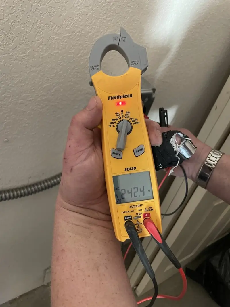 Voltage testing with clamp meter during Recessed Lighting Installation in Montrose-Ghent